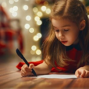 Small child writes the letter to Santa