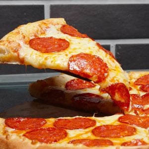 Slice of pizza pepperoni on scapula