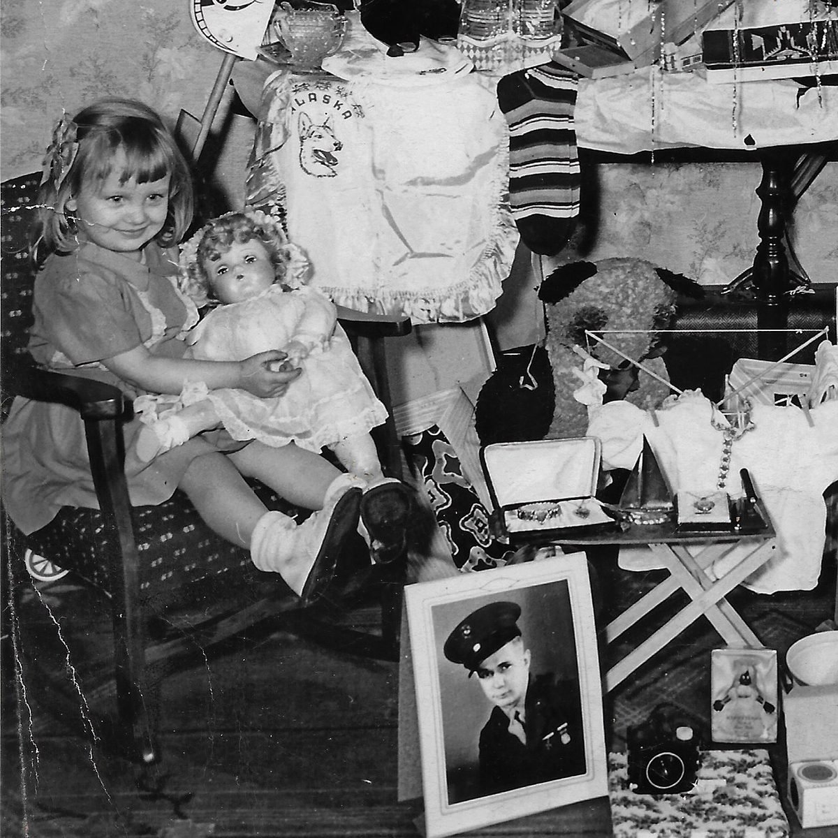 Photo of deployed family member beside the Christmas presents