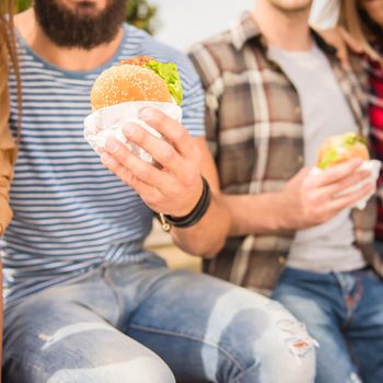 Sitting in the park and eat fast food