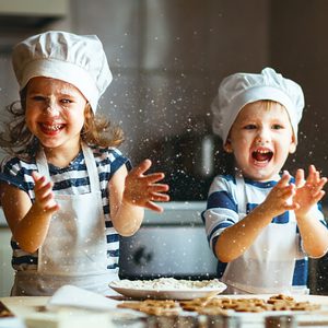 happy family funny kids are preparing the dough, bake cookies in the kitchen
