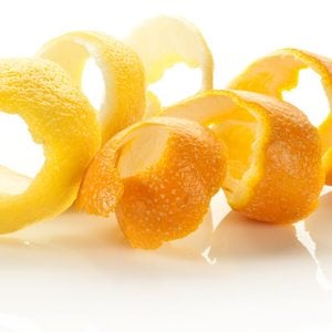 Twist of citrus peel on a white background.