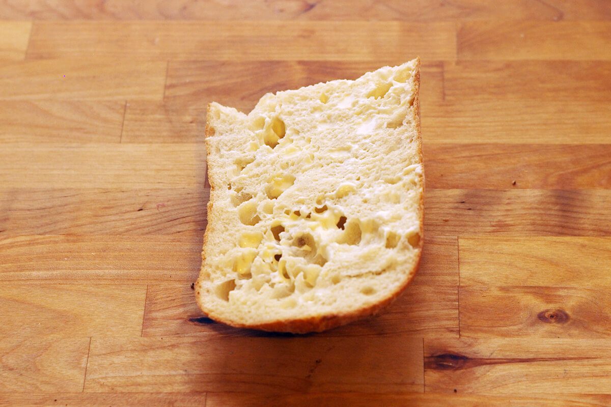 Piece of sliced bread on a wooden countertop