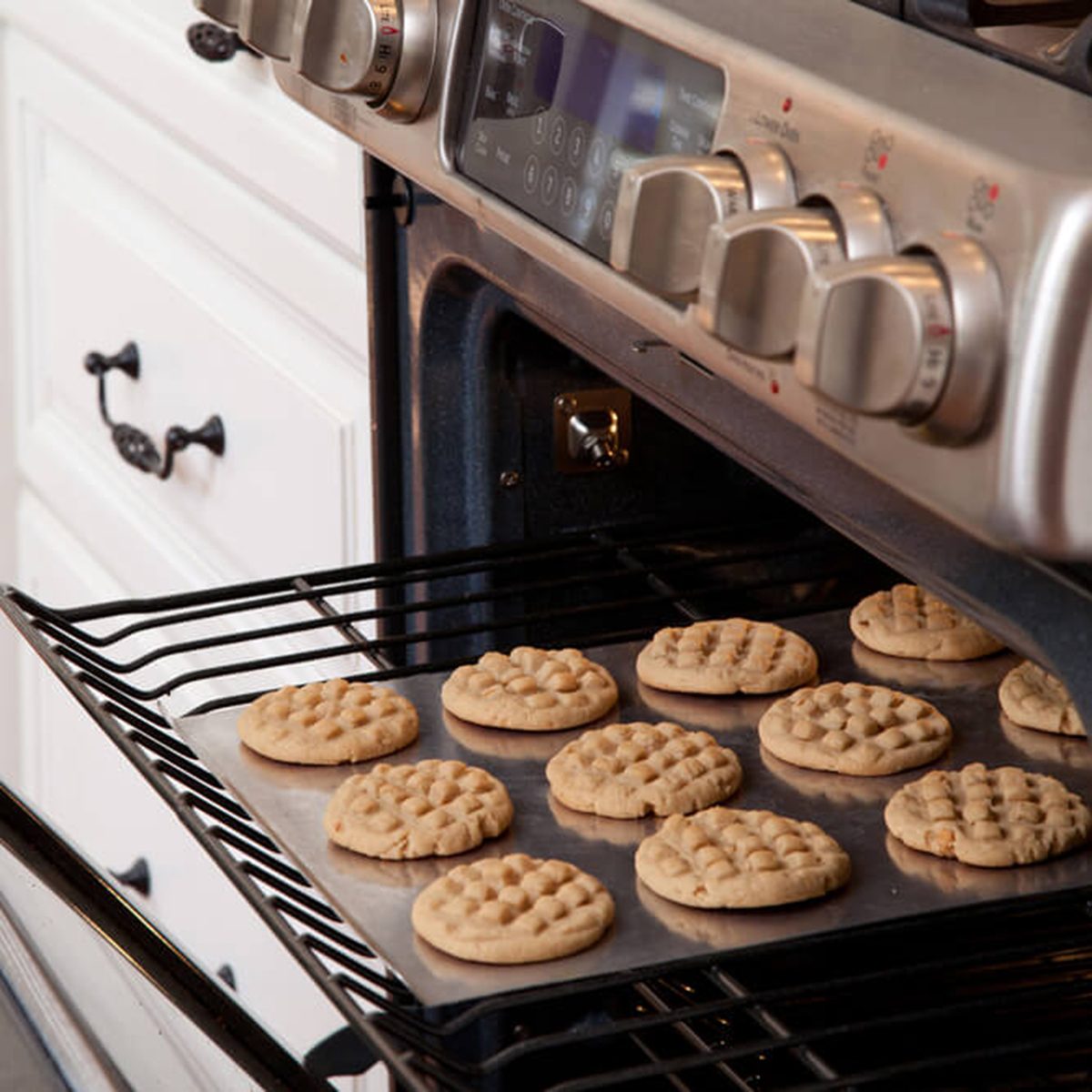 Tray of cookies coming out of the oven