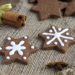 Star shape Christmas chocolate gingerbread Cookie with icing and cinnamon on sacking