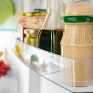 Different sauces on shelf in fridge