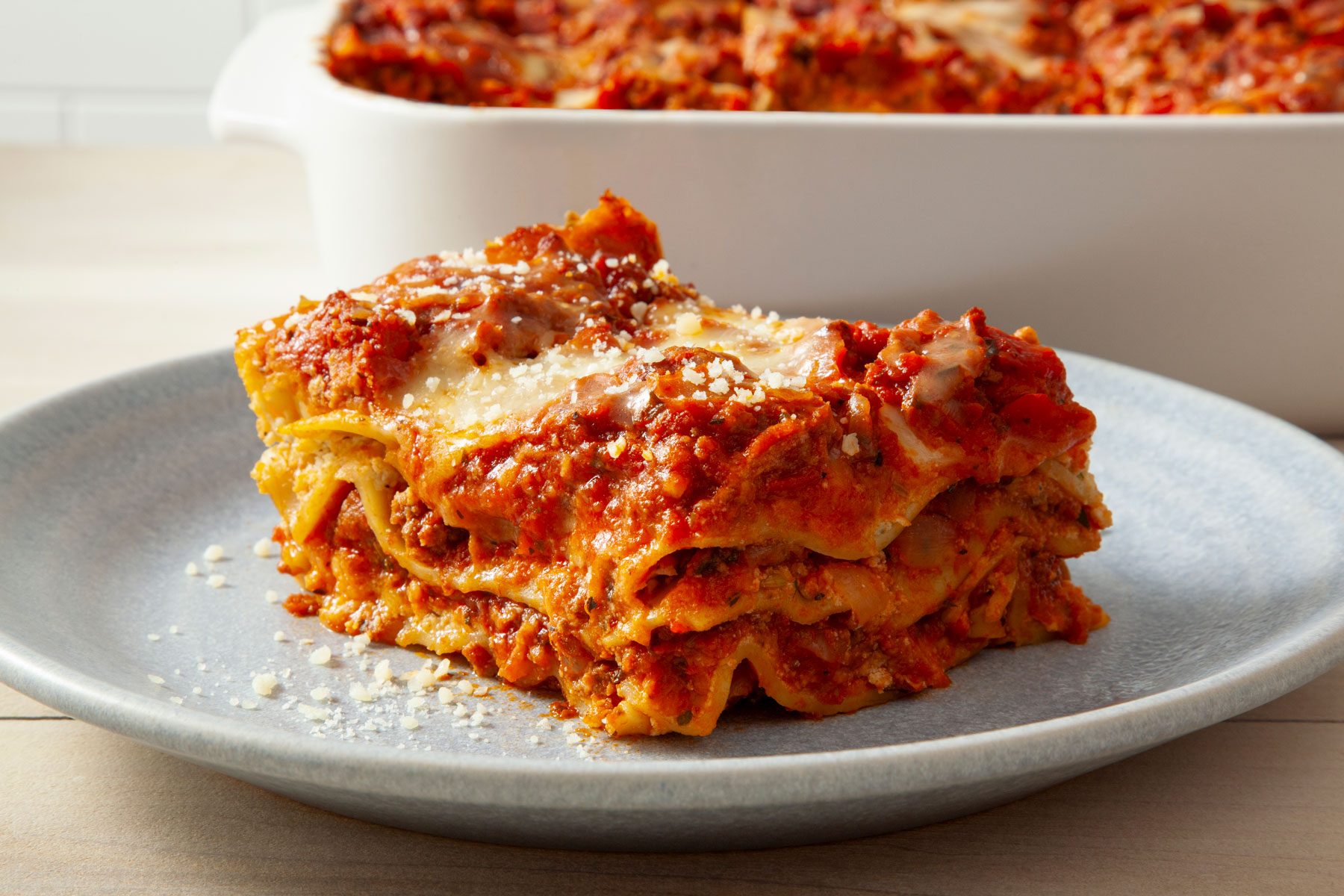 Lasagna served in a plate on a wooden table