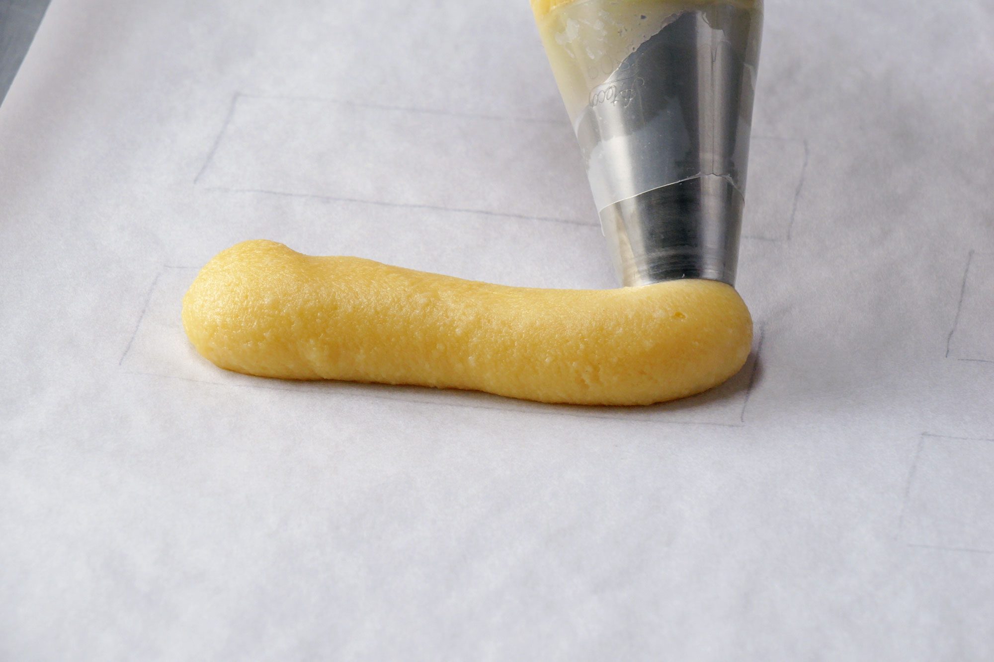 Chocolate Eclairs piping the eclair shells