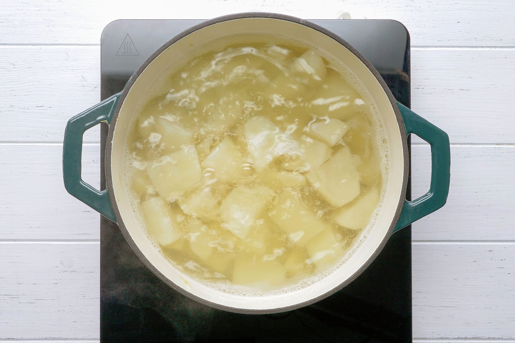 Boliling the potatoes in a large pan