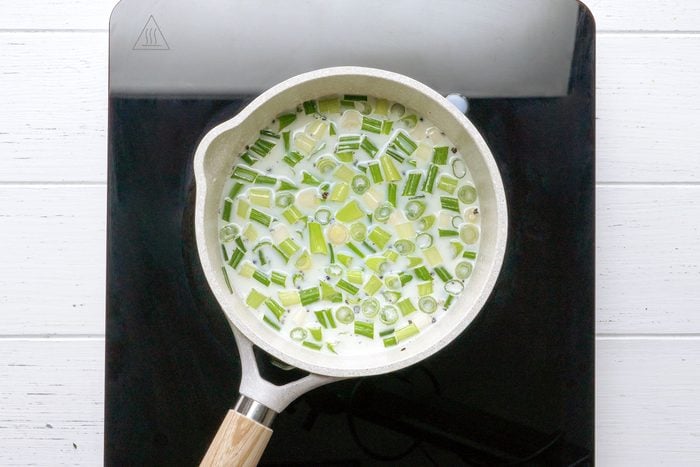 milk and green onions in a saucepan a