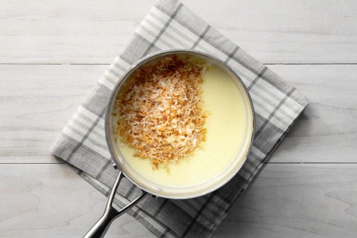 Coconut, butter and vanilla extract and milk in a saucepan