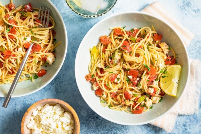Greek Spaghetti Served in Large Ceramic Bowl on Blue Background