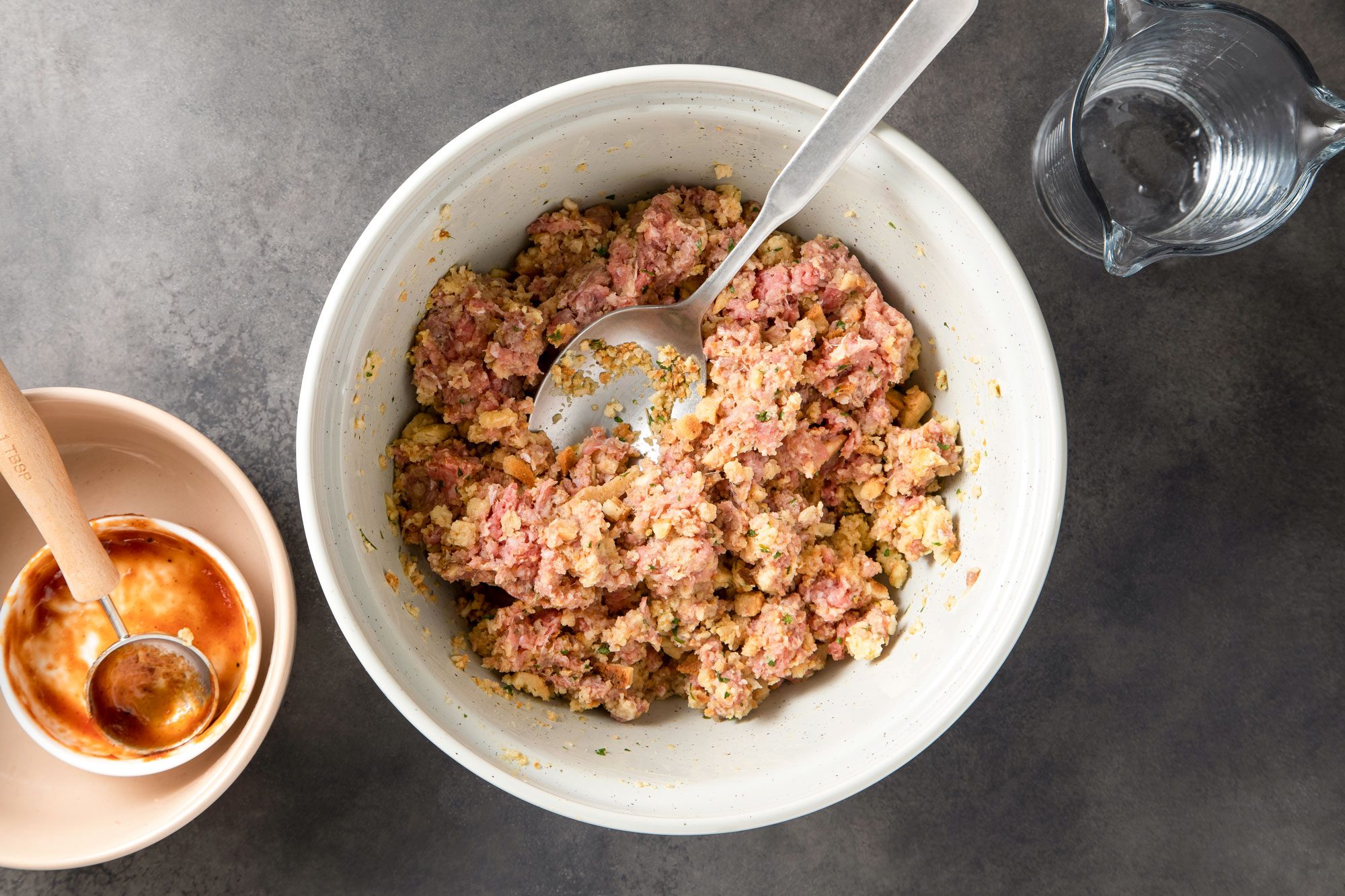 Mixing Mini Barbecue Meat Loaves Ingredients in a Large Ceramic Bowl