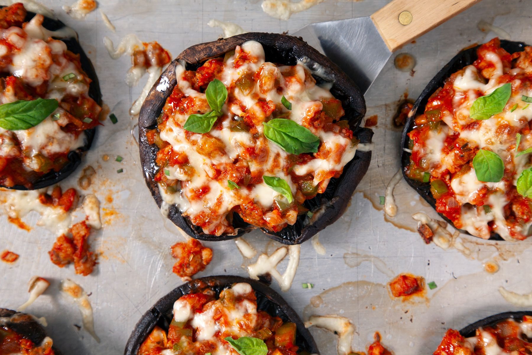 A close-up overhead short of backed Portobello Pizzas in a tray