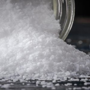 Kosher salt spilling from a spice jar