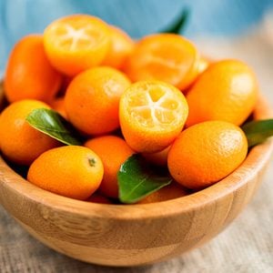 Kumquat or cumquat on wooden table
