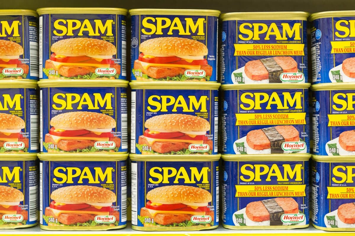 Spam canned meat stacked vertically in store shelf. 