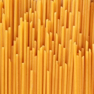 Uncooked spaghetti noodle abstract;