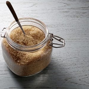 Brown sugar in glass jar on wooden table