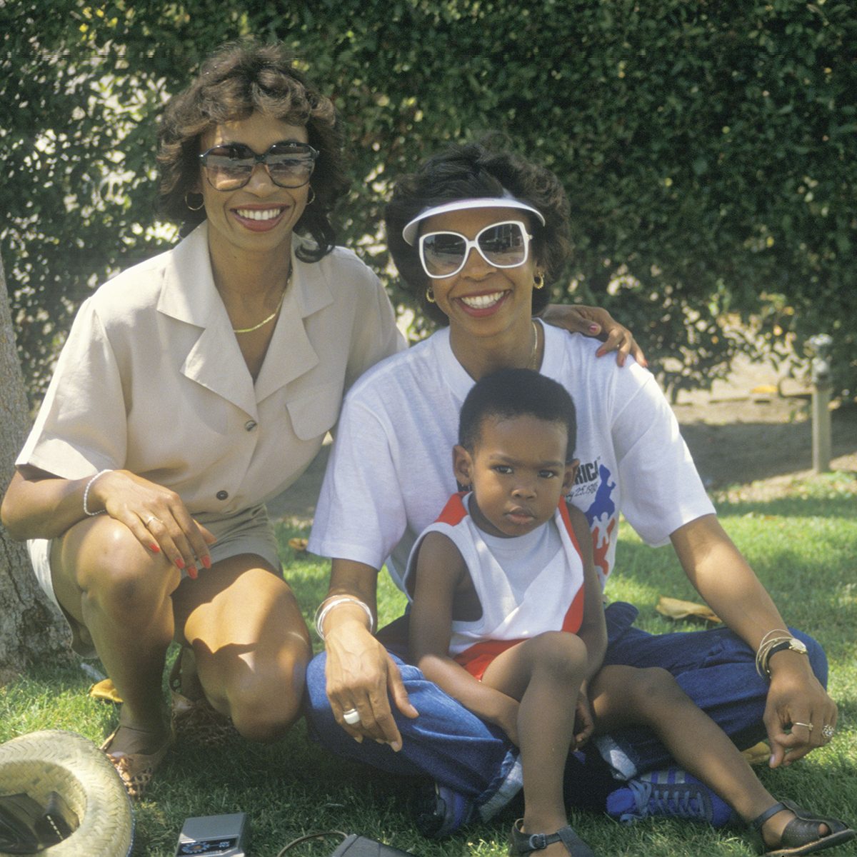 Mandatory Credit: Photo by Stock Connection/REX/Shutterstock (2395690a) African - American women and child sitting under a tree, Los Angeles, CA. VARIOUS