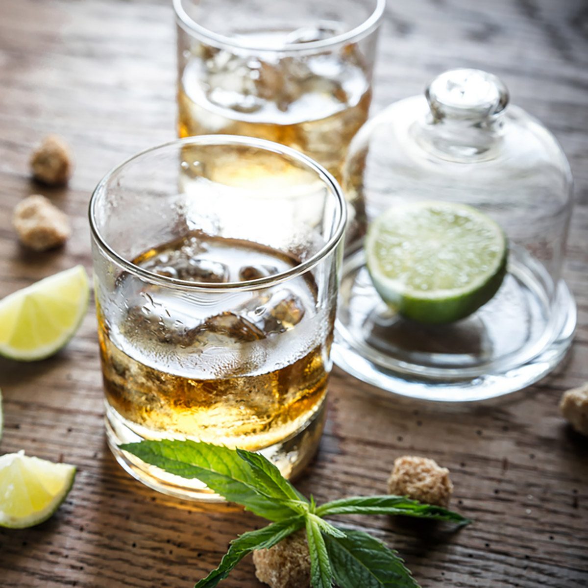 Glass of rum on the wooden background