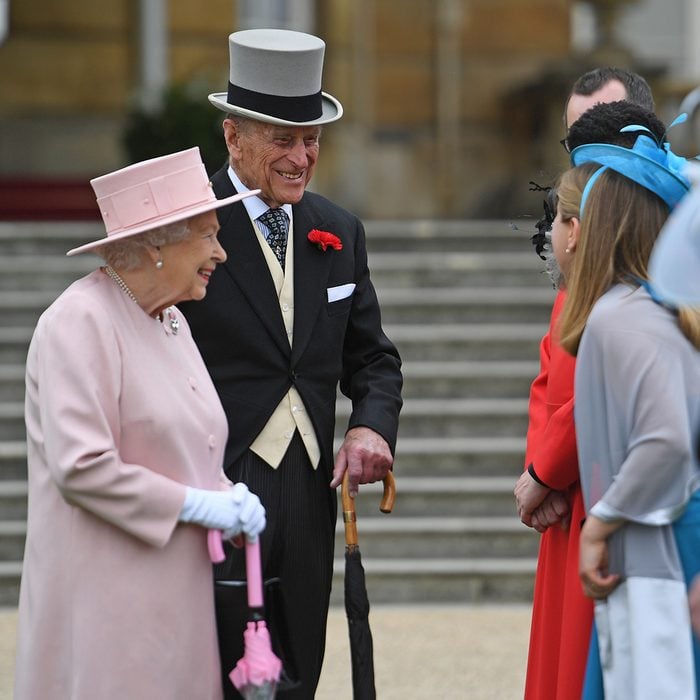 Queen Elizabeth II and Prince Philip talk to guests during a garden party at Buckingham Palace in London.