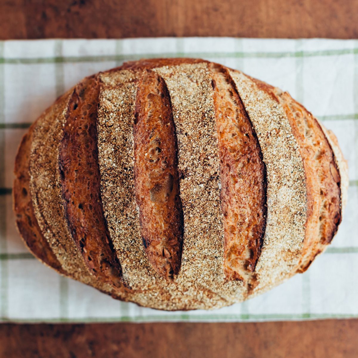 Tasty rustic bread on wooden table
