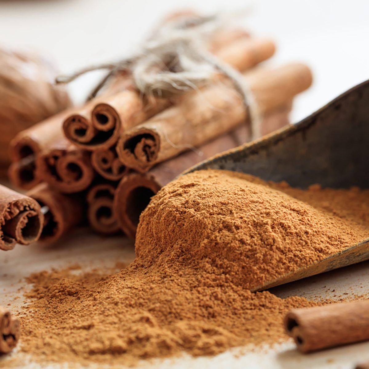 Cinnamon sticks and powder on a wooden table.