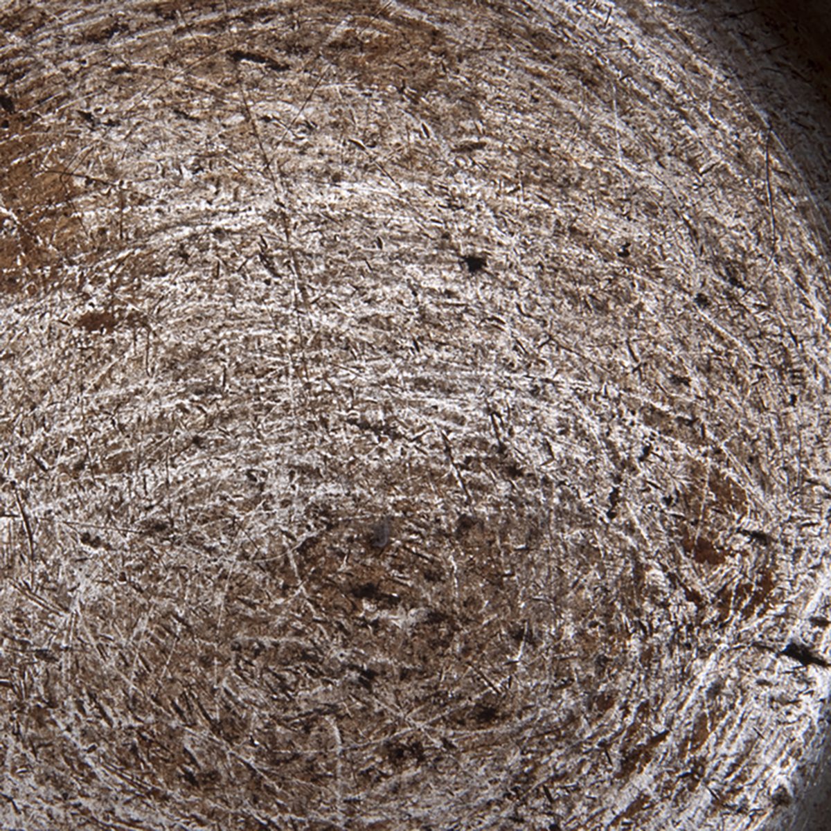 Inside of a scratched dirty kitchen pot.