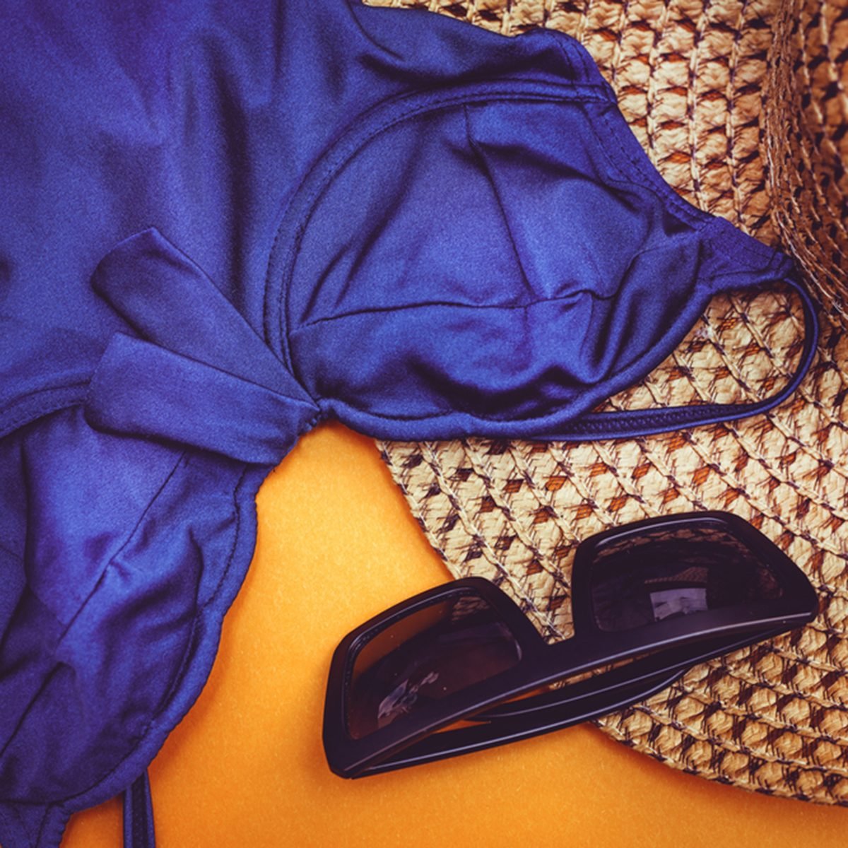 Beach straw hat with blue swimsuit and sunglasses