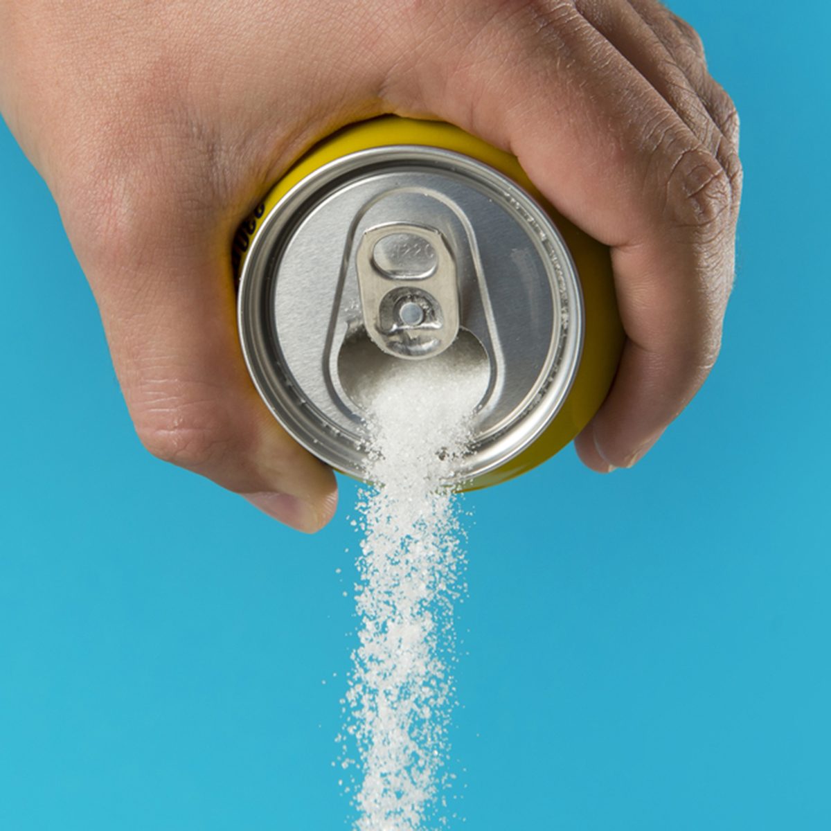 man hand holding refresh drink can pouring sugar stream in sweet and calories content of soda and energy drinks