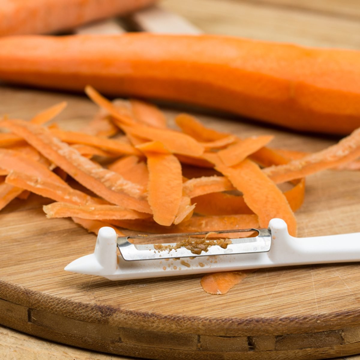 Peeled fresh raw carrots on the cutting board.