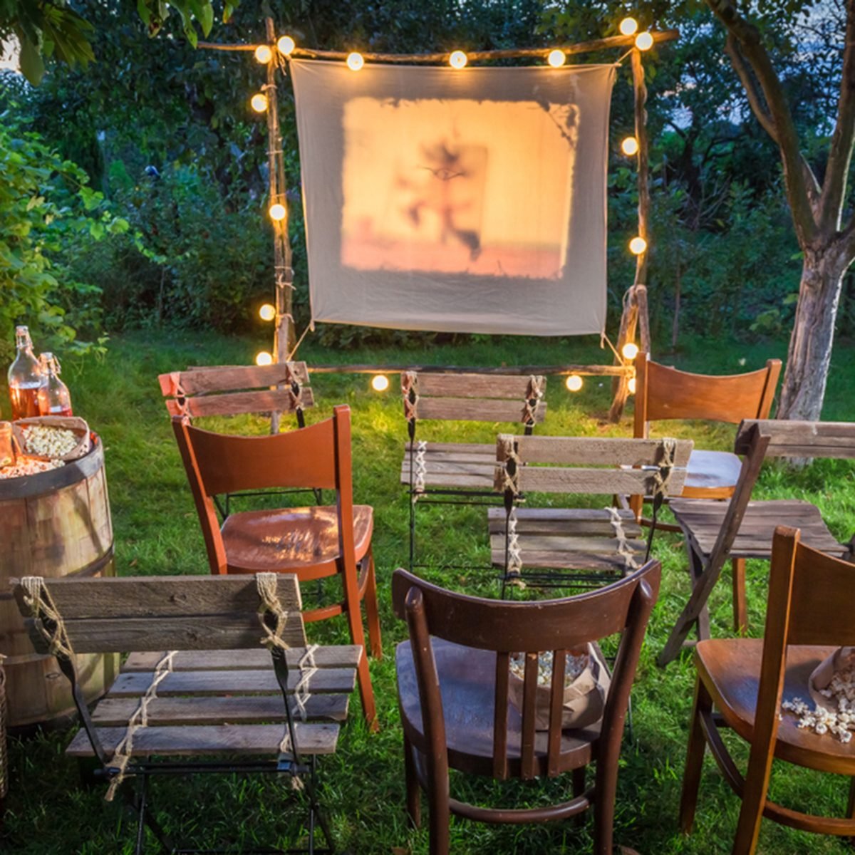 Summer cinema with retro projector in the garden