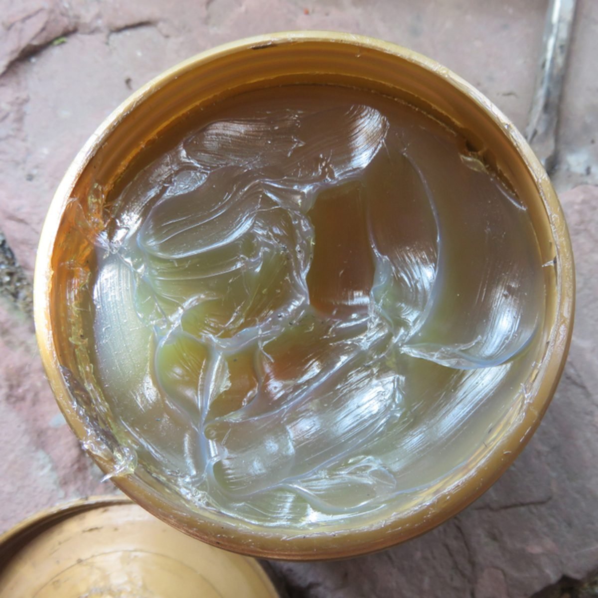 Grease or semisolid lubricant in a plastic container