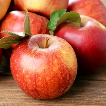 Ripe red apples on wooden background