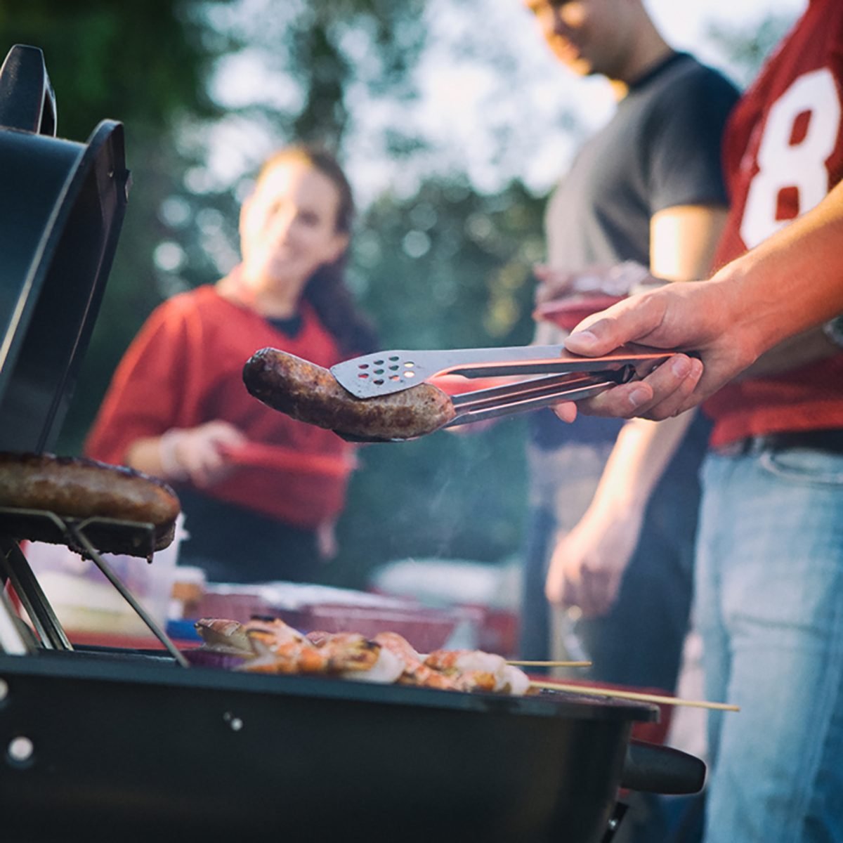 Tailgate: Man Works The Grill At Tailgating Party