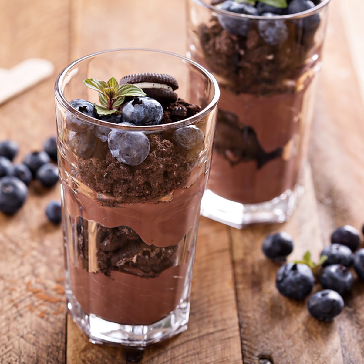 Chocolate pudding parfait mud pie with cookie crumbs and blueberry