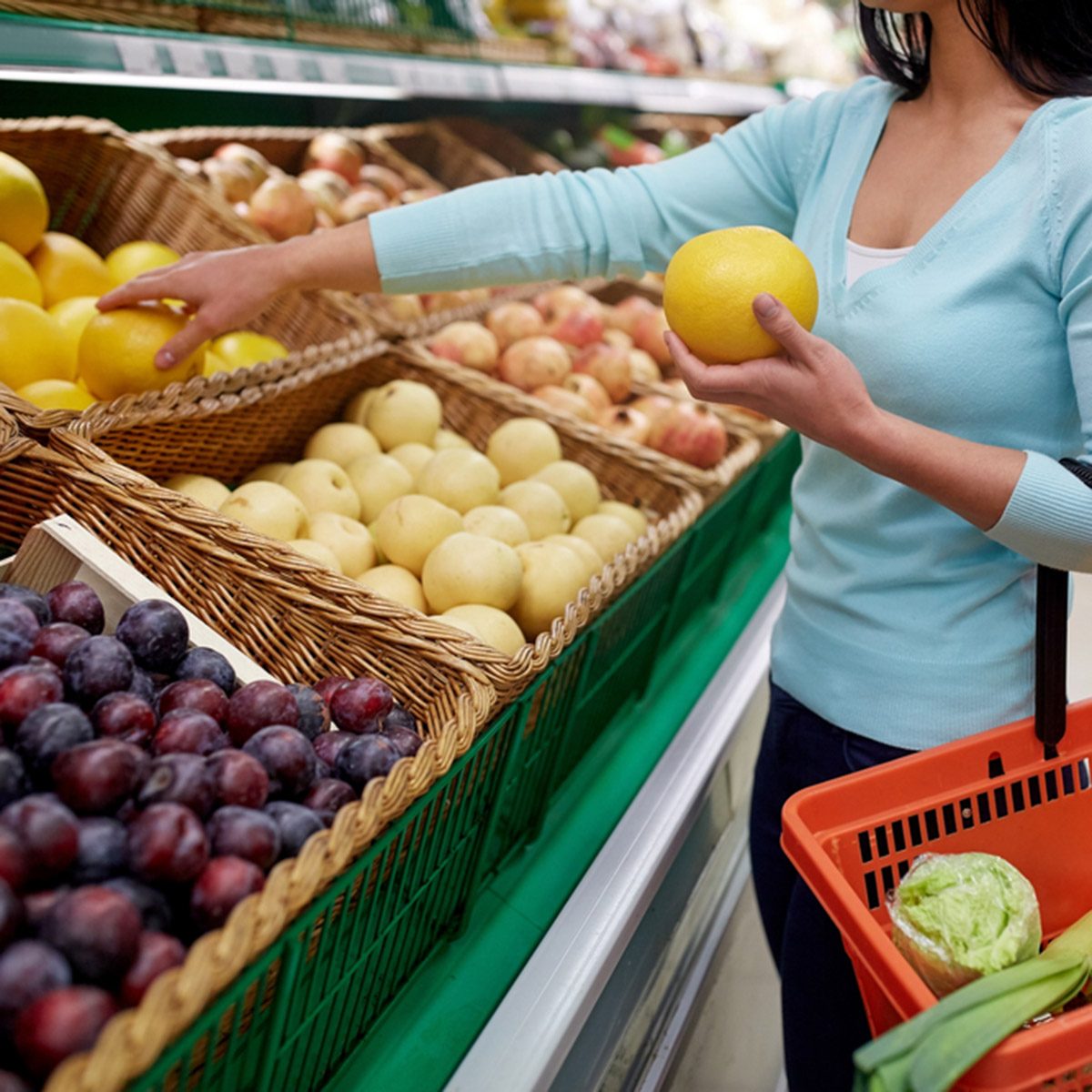 sale, shopping, food, consumerism and people concept - woman with basket buying pomelo at grocery store; Shutterstock ID 558274159; Job (TFH, TOH, RD, BNB, CWM, CM): Taste of Home