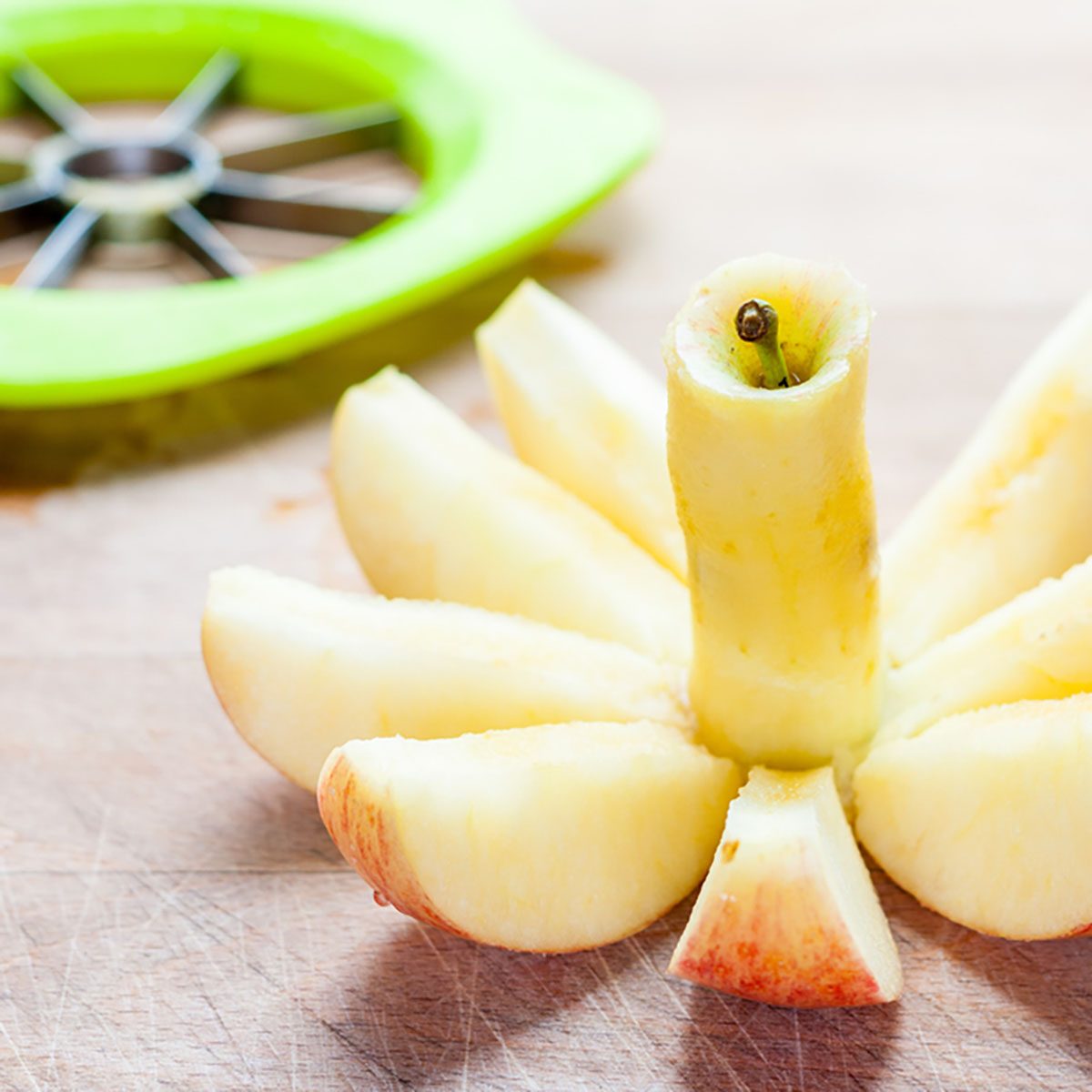 A cored and sliced gala apple with a corer and slicer in the background; Shutterstock ID 328132535