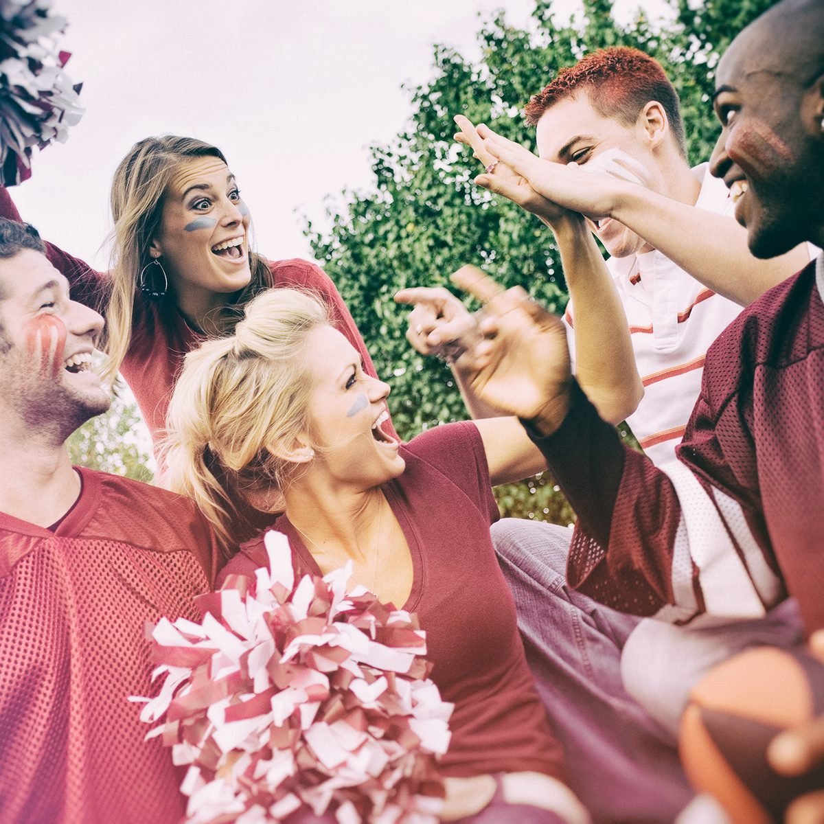 Tailgating: College Student Fans Give High Five For Team Win