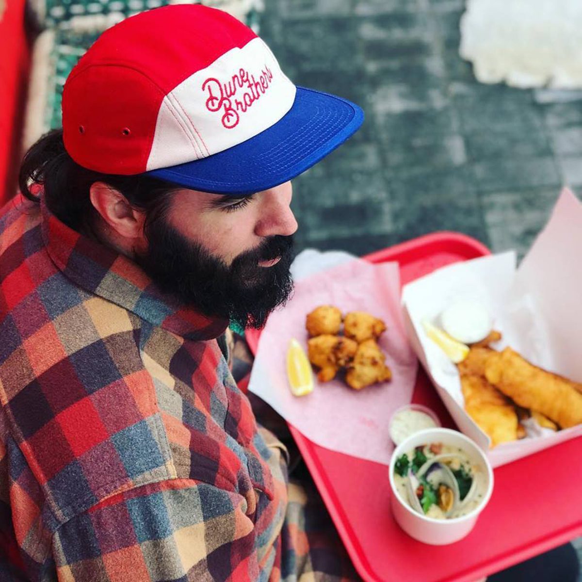Man eating clam cakes