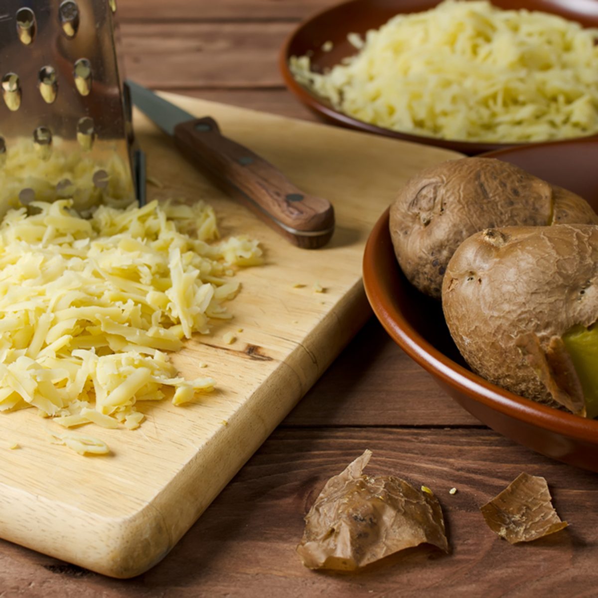 Boiled potatoes and grated the potatoes on a cutting board.