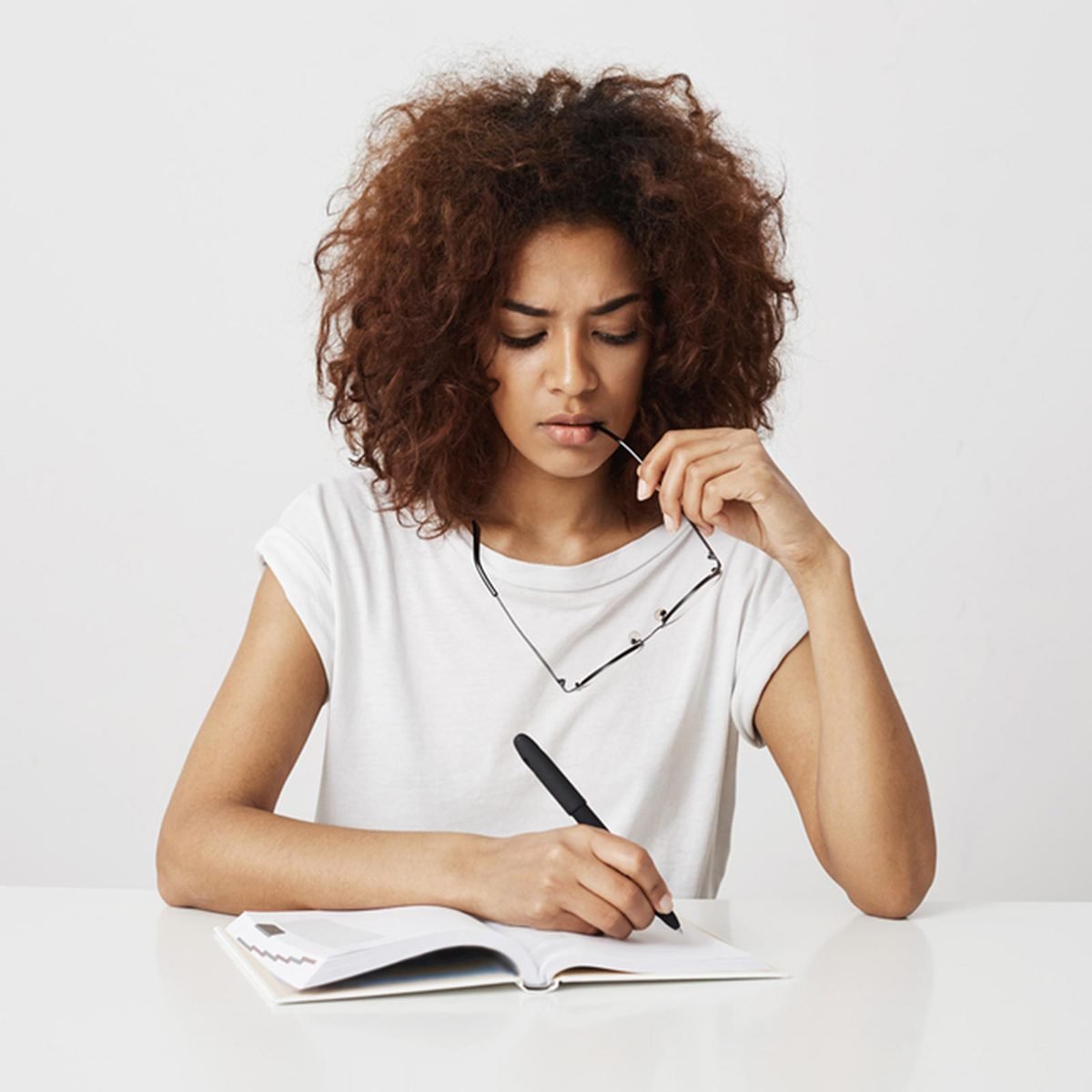 Woman thinking and taking notes