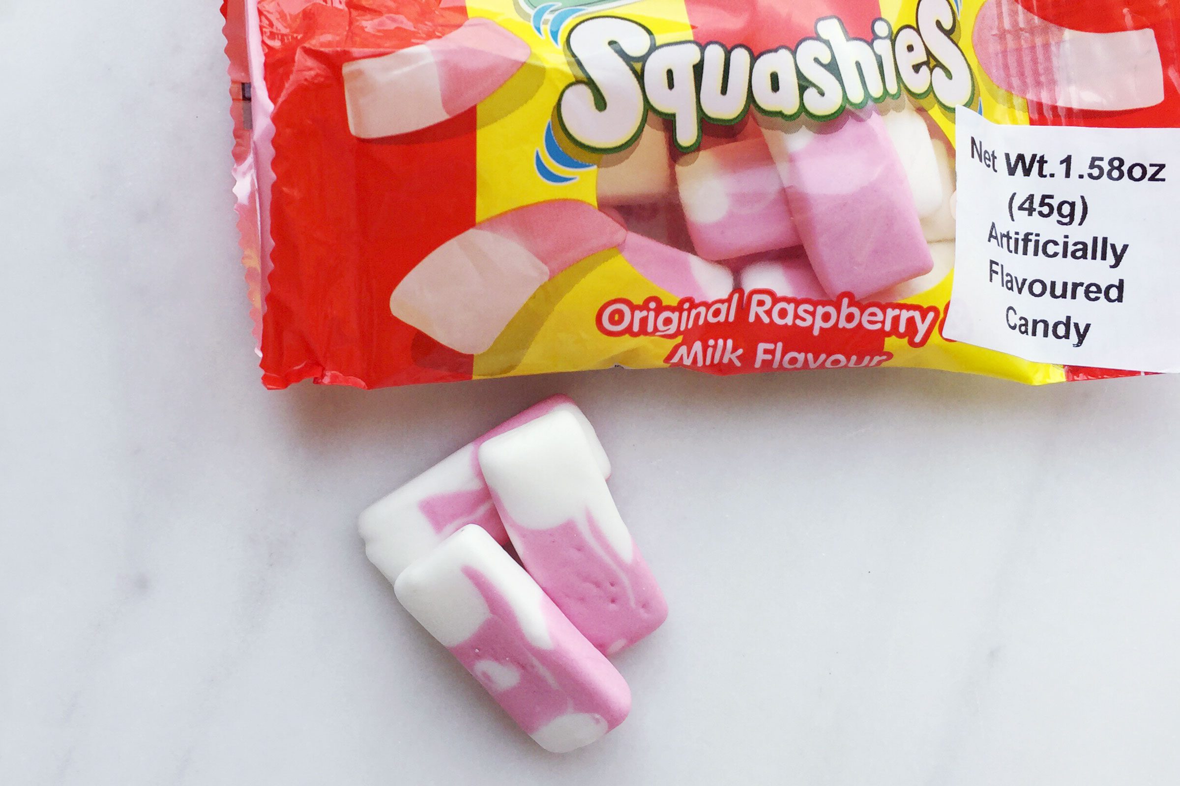 Drumstick Squashies British candy on a marble surface