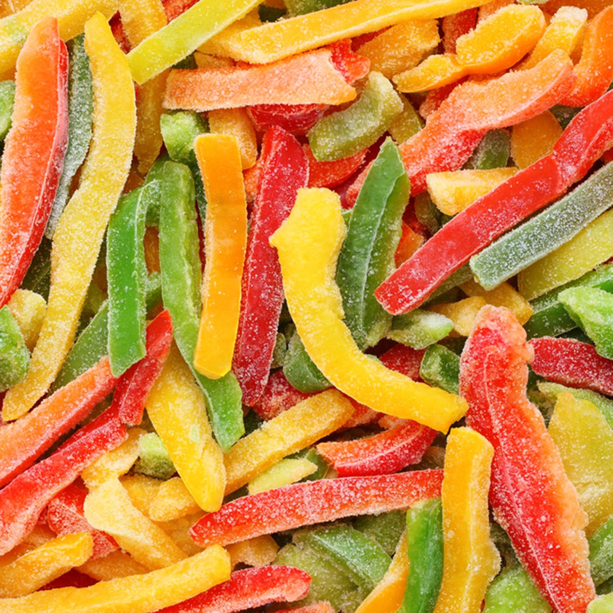 Frozen multicolored peppers background