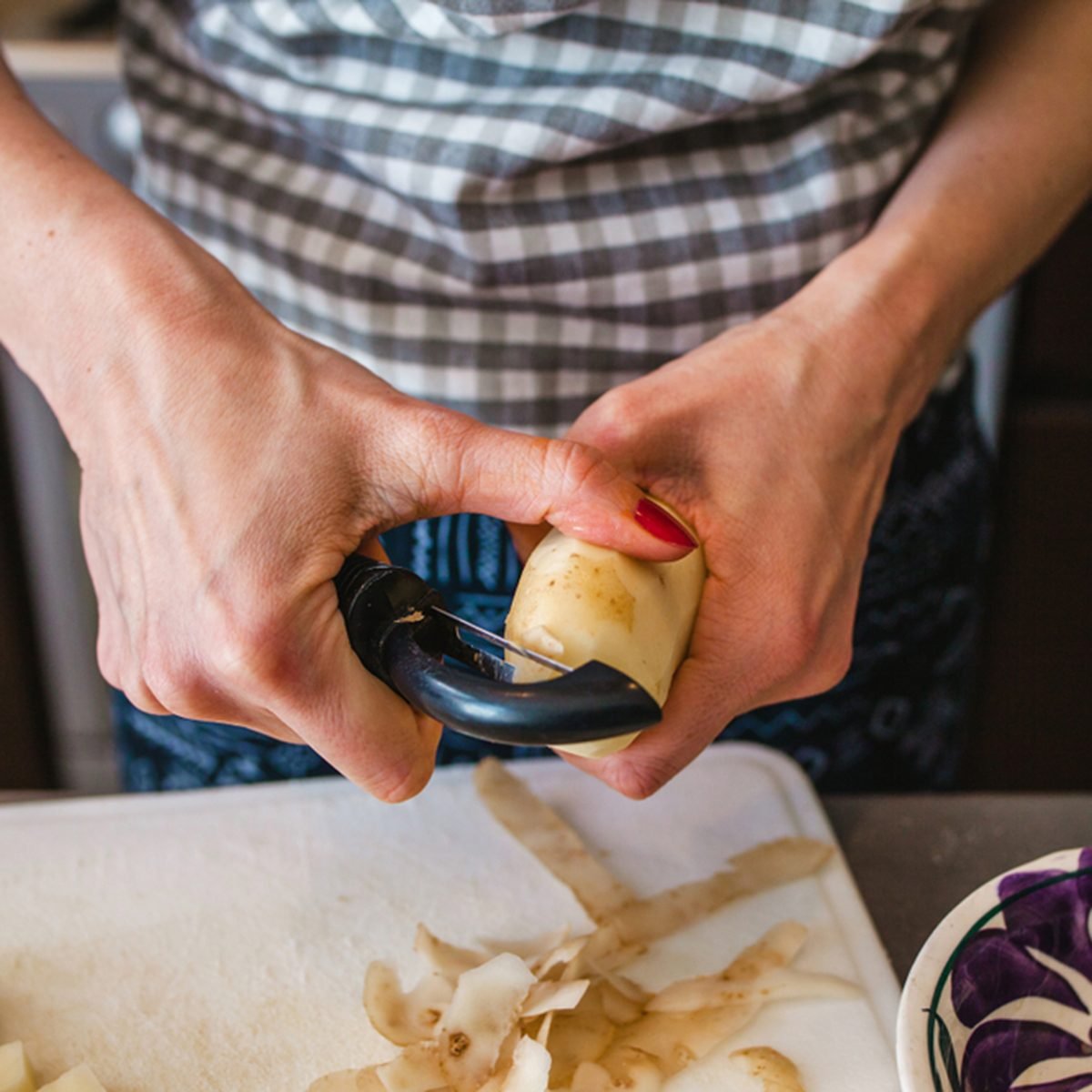 potato is peeled, woman hands, cooking food in kitchen