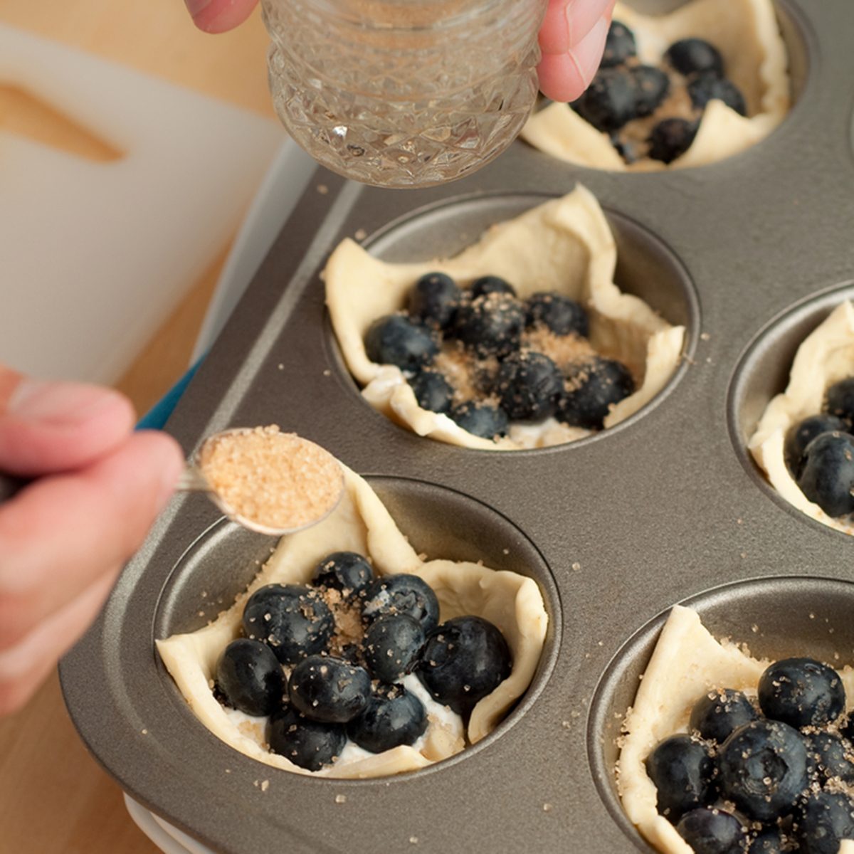 Hand Sprinkling Brown Sugar on Pastry; Shutterstock ID 58017457; Job (TFH, TOH, RD, BNB, CWM, CM): Taste of Home