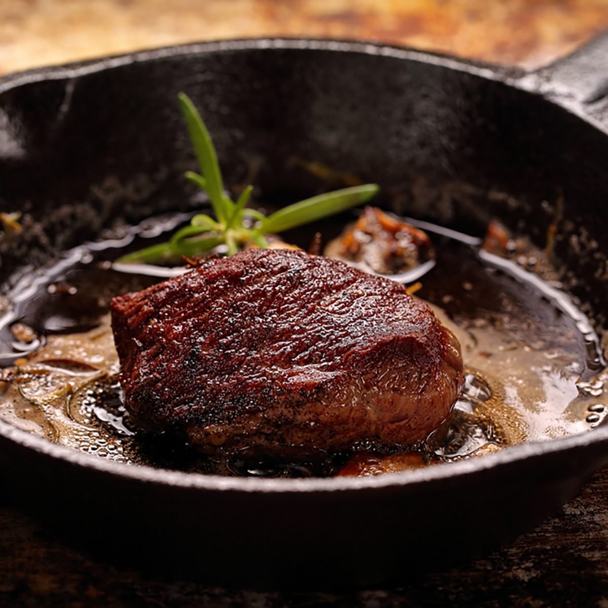 Beef steak on cast iron skillet with empty space for text