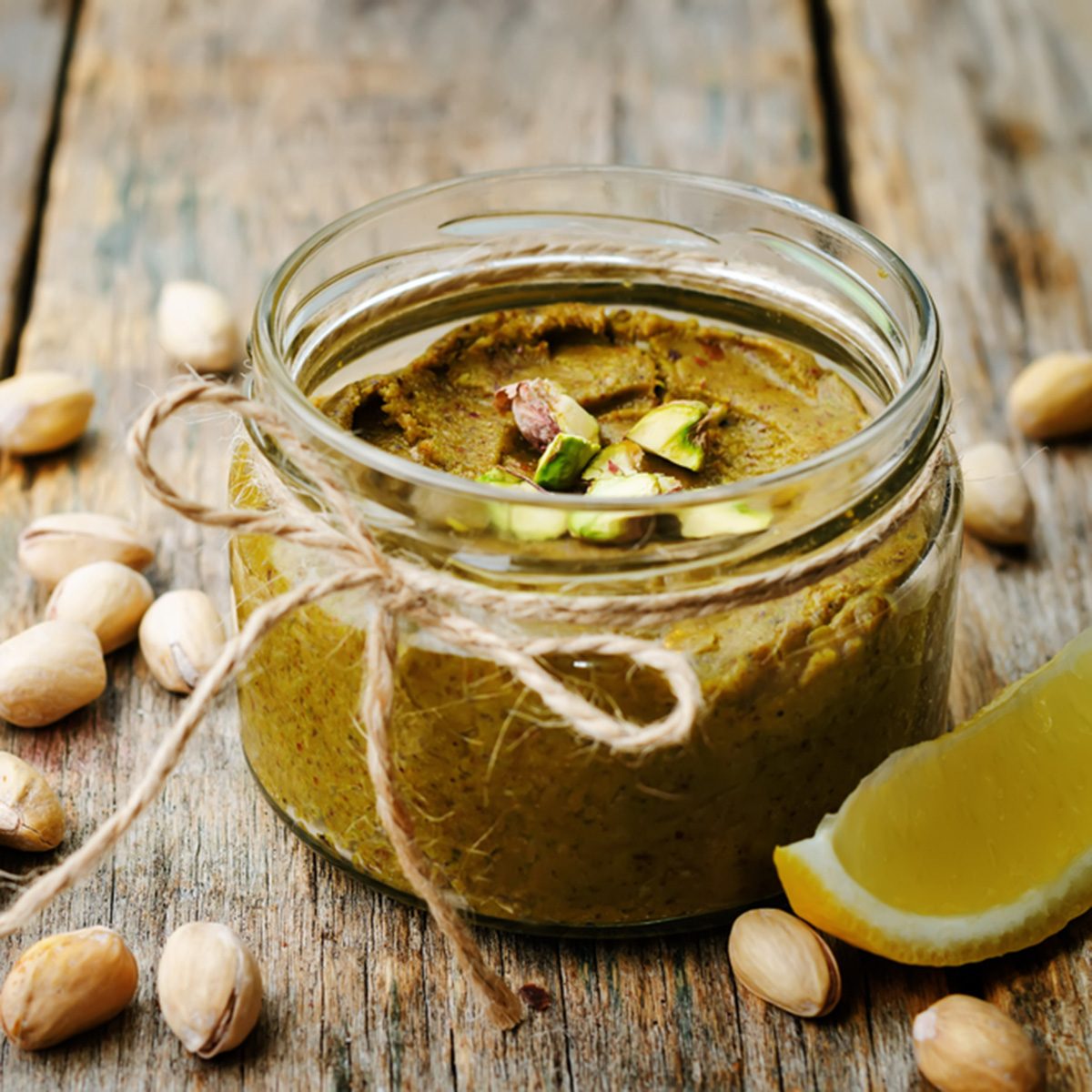toasted pistachio lemon butter on a dark wood background.
