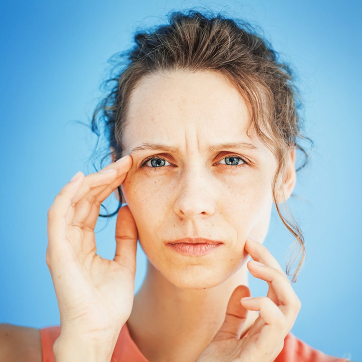 woman unhappy with her mimic wrinkles on face